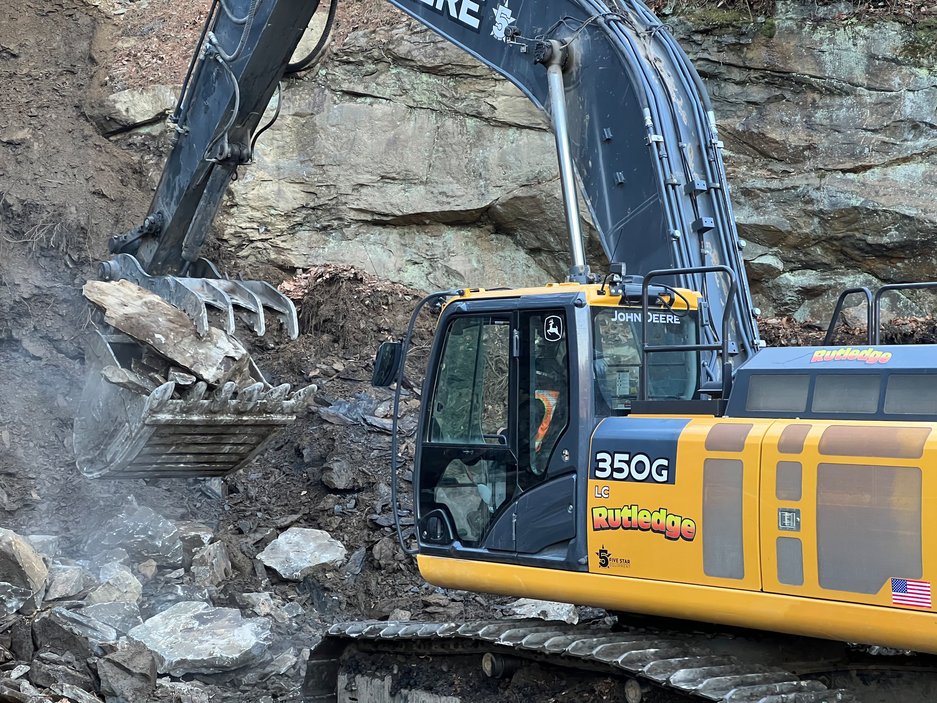 A Rutledge excavator grabs rock on a mountainside in Pennsylvania for use in a stream bed.