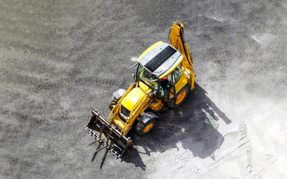 A solar panel on a backhoe loader.