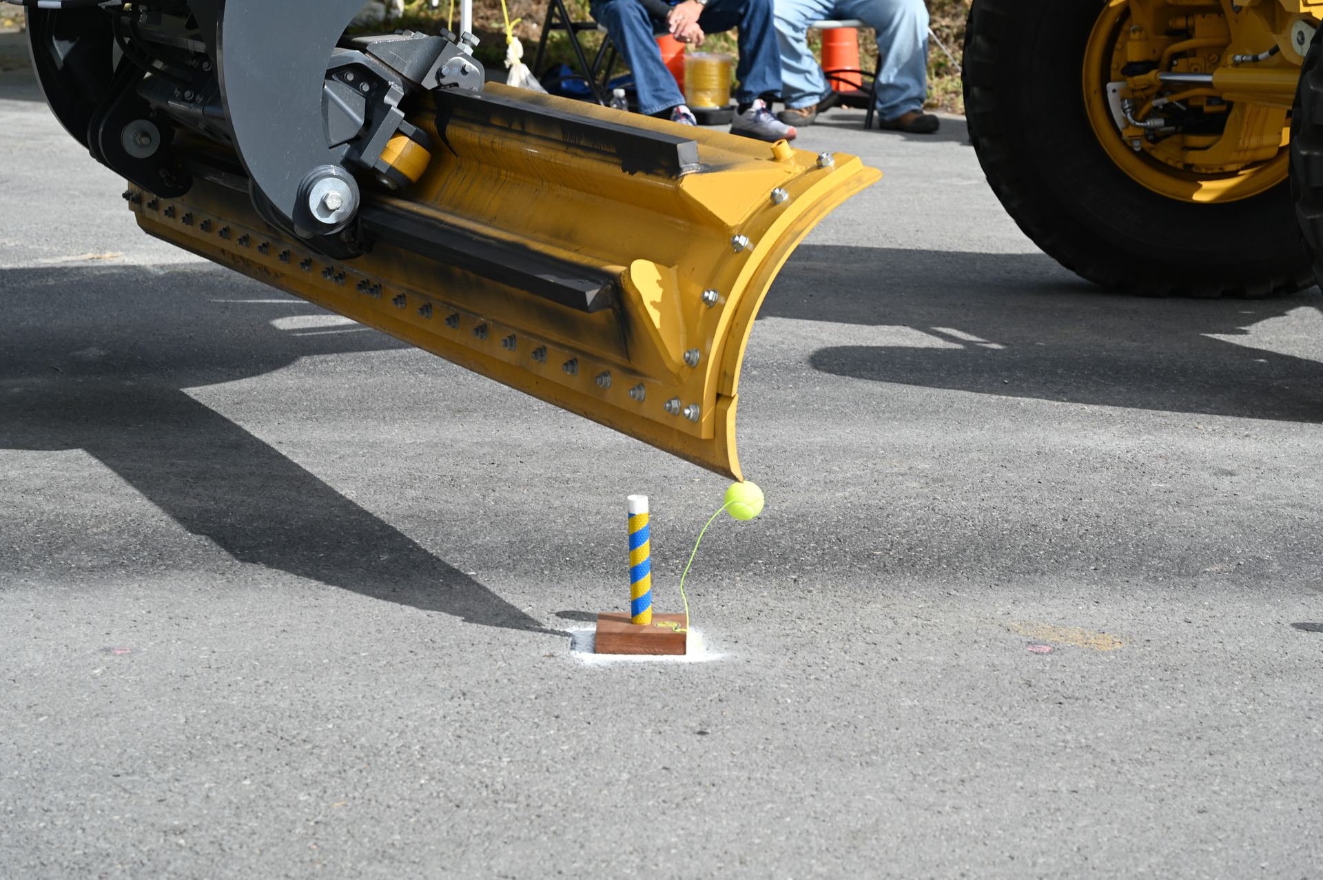 A Motor Grader Blade Knocks Over A Ball
