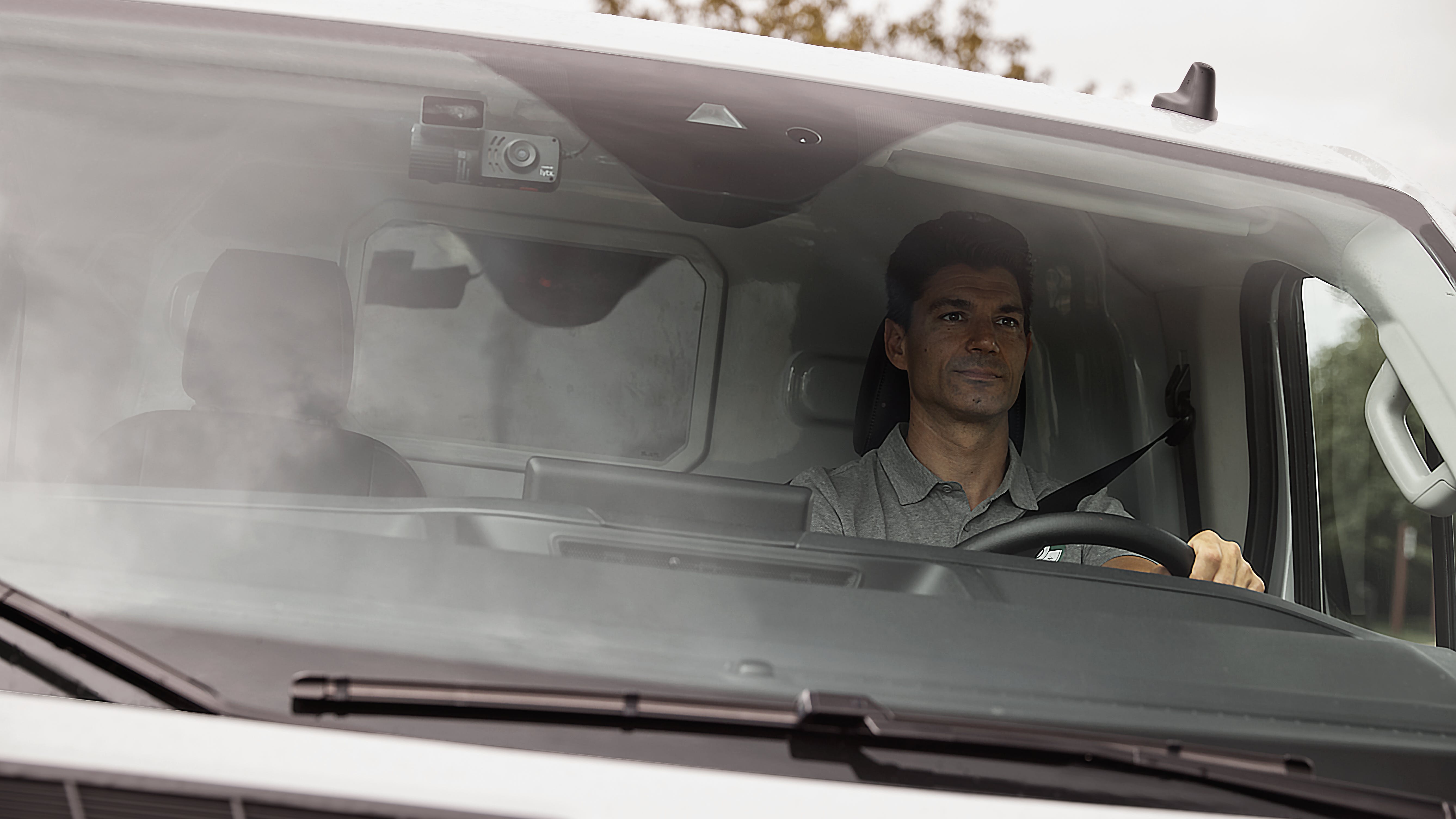 Window-mounted Lytx dashcam provides road-facing and in-cab footage.
