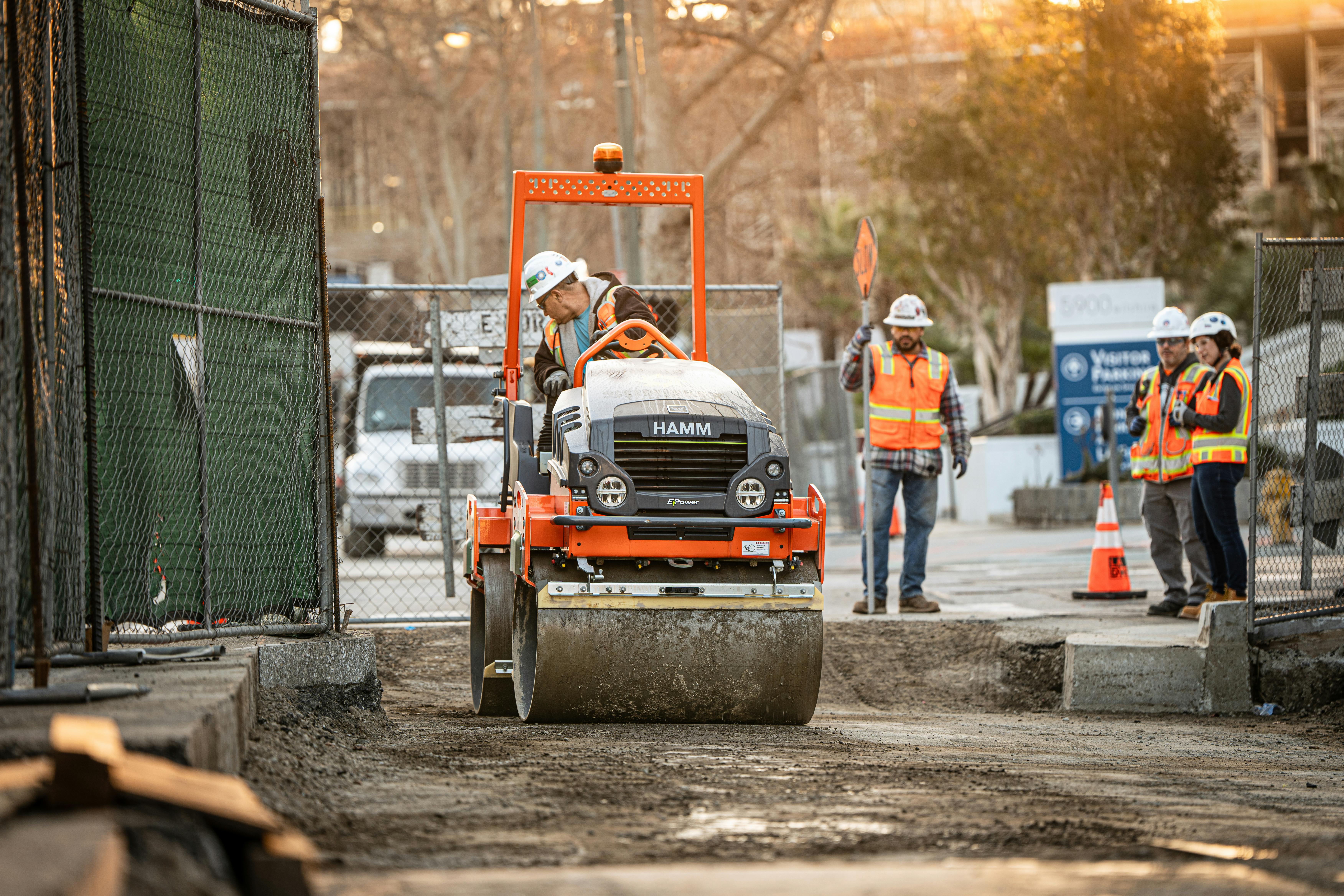 Skanska is using a Hamm electric roller to compact subgrade and crushed aggregate at the Fairfax station in Los Angeles.