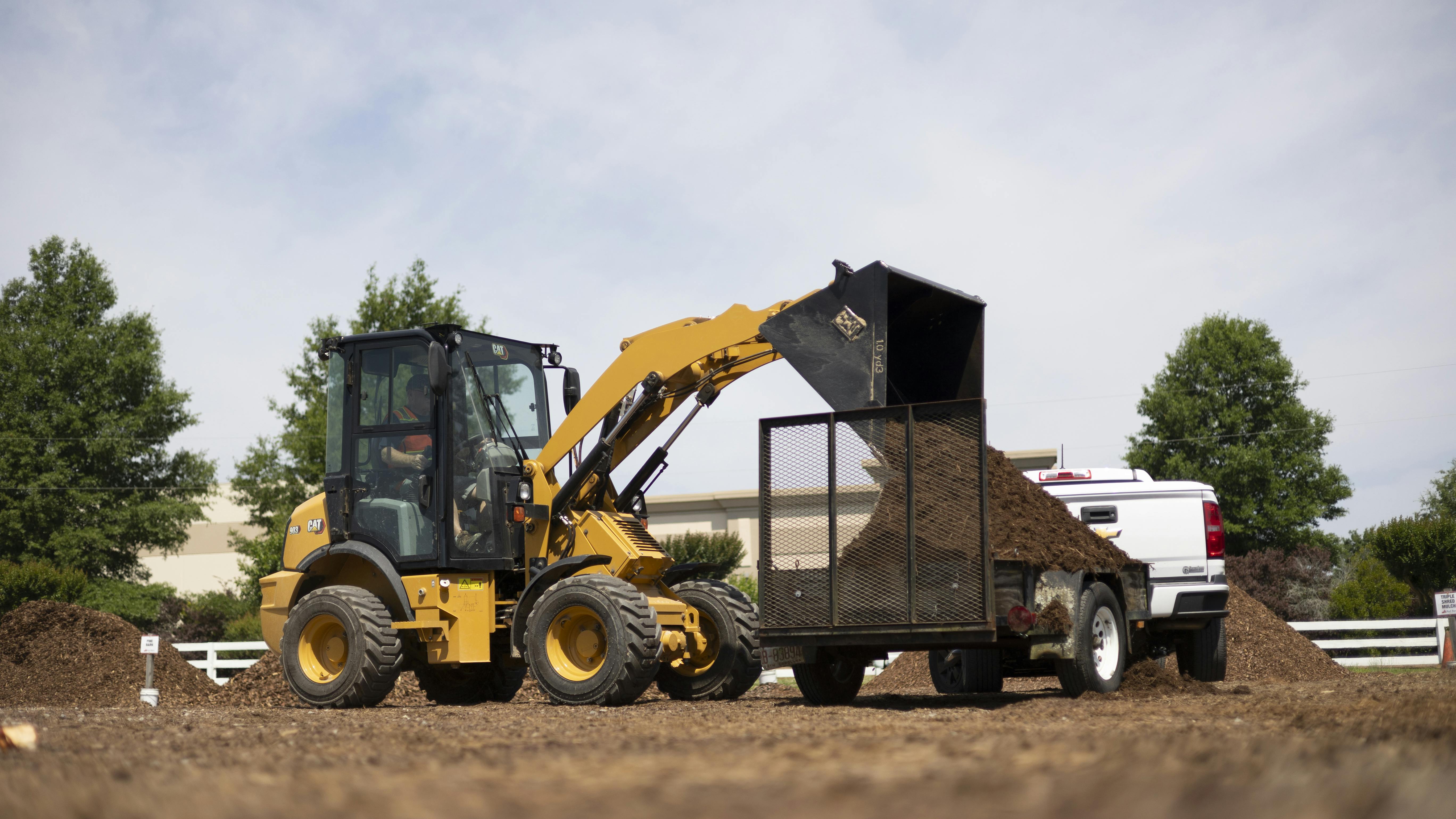 Caterpillar 903 compact wheel loader features hinge pin height of 10 feet.