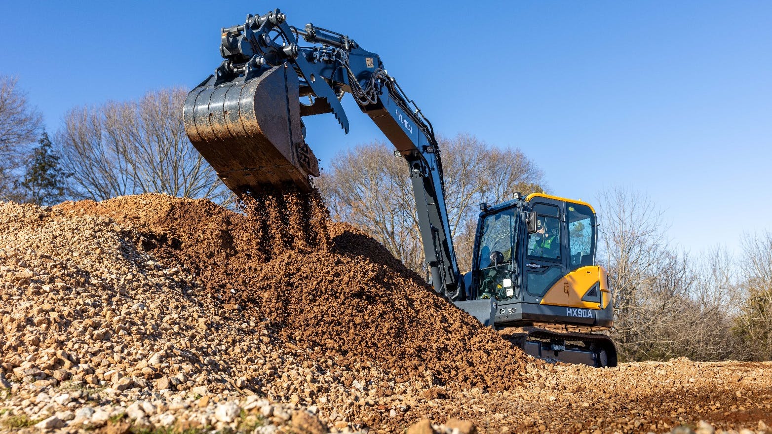 The Hyundai HX90A excavator has a maximum dig reach of 23 feet 3 inches.