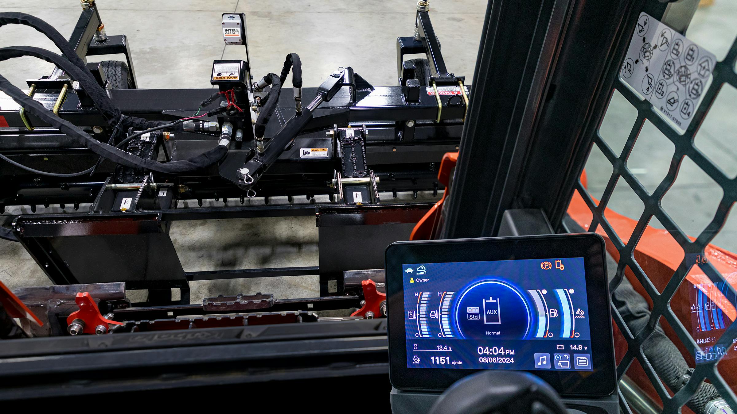 Information from the attachment is displayed in the cab. The 2x2-inch tag is affixed to the attachment (upper part of photo).