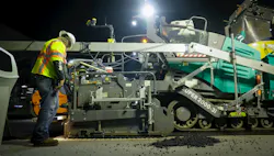 Vögele Products paver with worker on the side Vögele Products paver with worker on the side