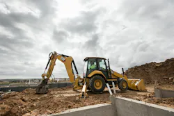Caterpillar 440 backhoe loader using a compaction plate attachment Caterpillar 440 backhoe loader using a compaction plate attachment