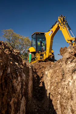 Caterpillar 416 backhoe loader digging a trench Caterpillar 416 backhoe loader digging a trench