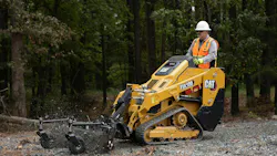 Cat mini track loader spreading mulch Cat mini track loader spreading mulch