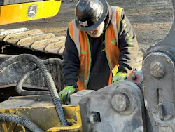 Worker inpsects equipment Worker inpsects equipment