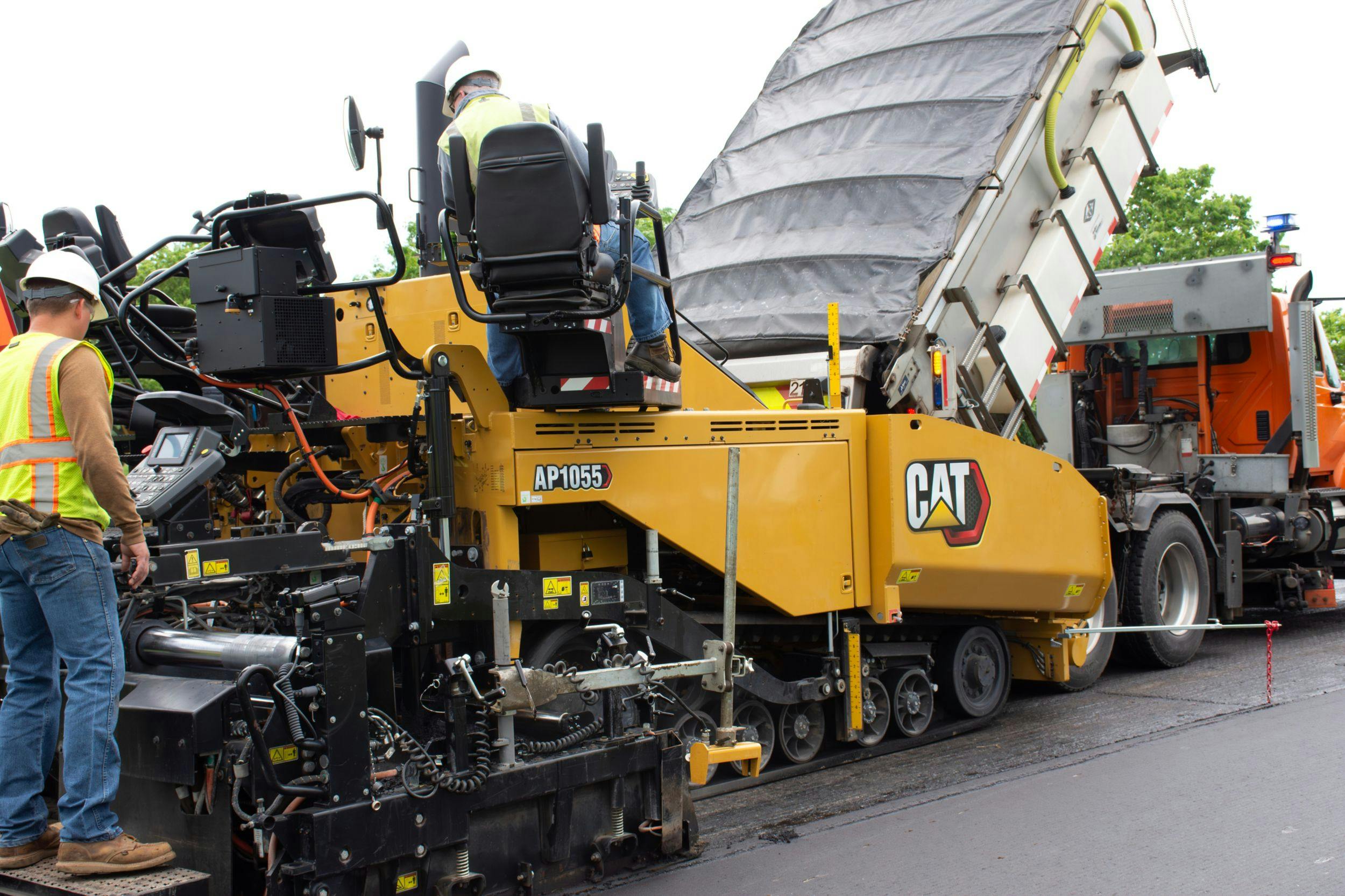 Caterpillar AP1055 Paver working a road.