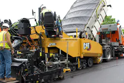 Caterpillar AP1055 Paver working a road. Caterpillar AP1055 Paver working a road.