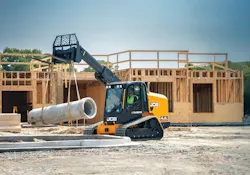 JCB 4TS-8T Teleskid lifting a concrete pipe by a housing project. JCB 4TS-8T Teleskid lifting a concrete pipe by a housing project.