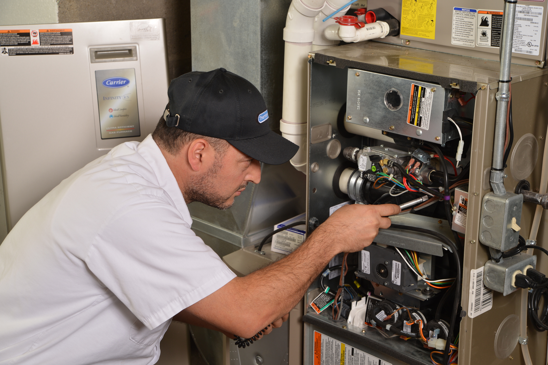 technician servicing furnace