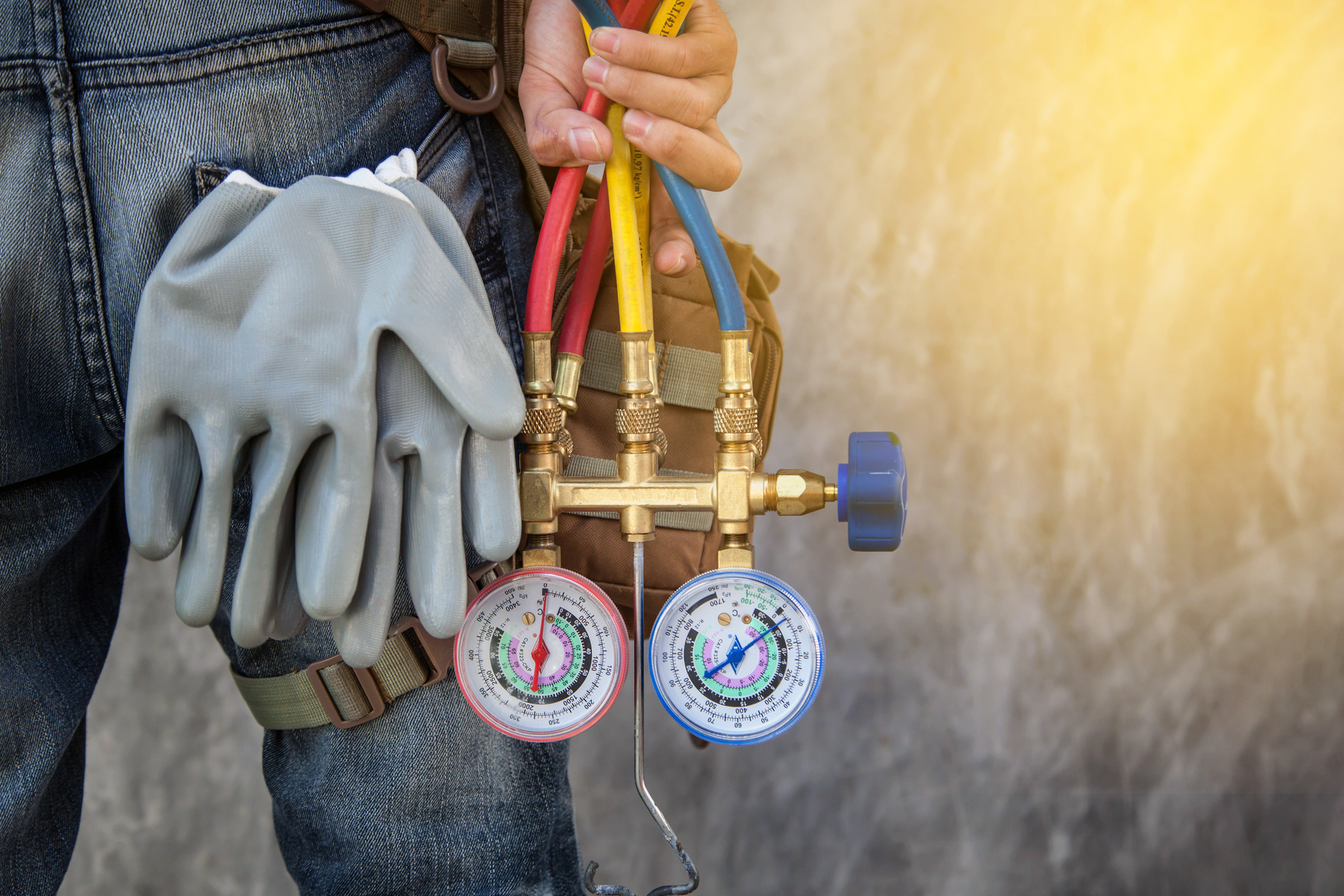 HVAC technician holding gauges