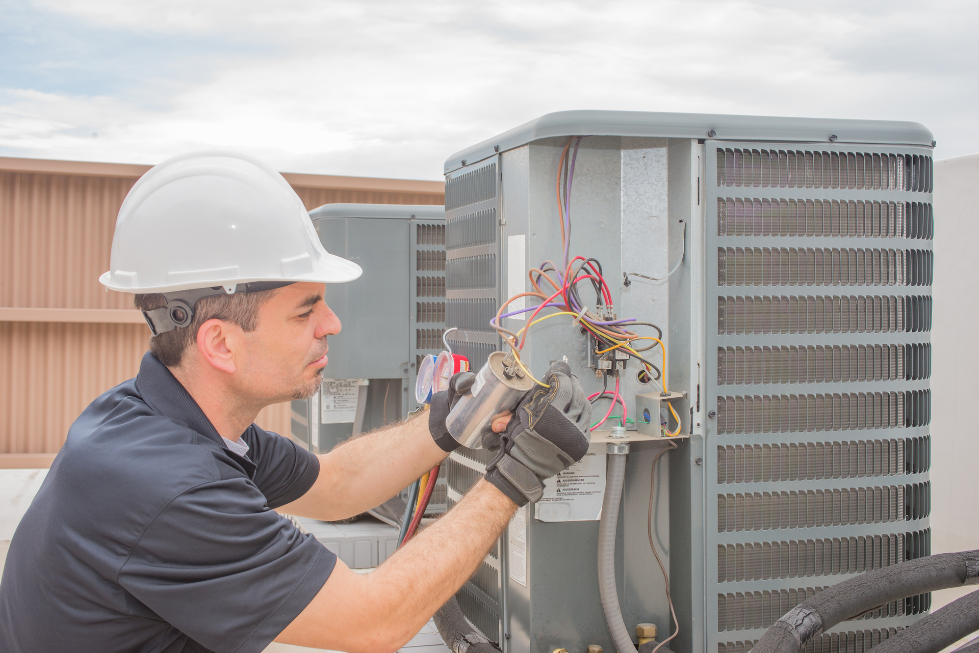 technician working rooftop unit
