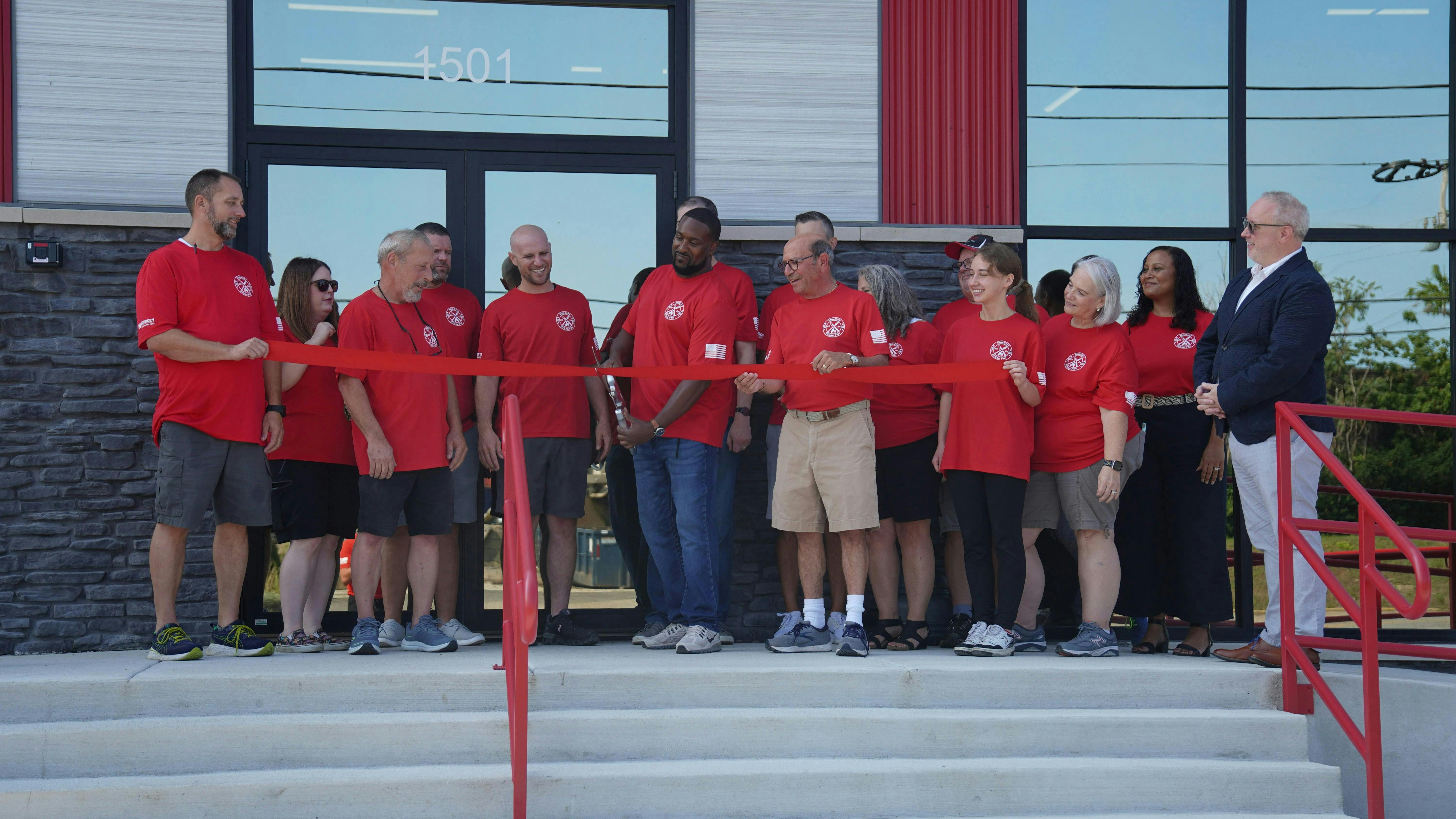 MId-City Supply employees gather for the ribbon-cutting at its renovated location.