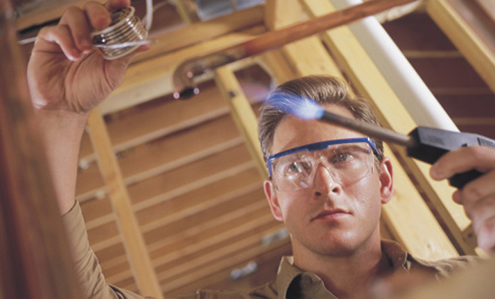 Plumber welding pipe