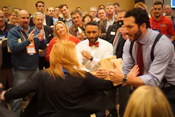 Nexstar member Tammy Ferris breaking through a board held by Keith Mercurio while Nexstar Training Manager Julian Scadden and the crowd cheer her on Nexstar member Tammy Ferris breaking through a board held by Keith Mercurio while Nexstar Training Manager Julian Scadden and the crowd cheer her on
