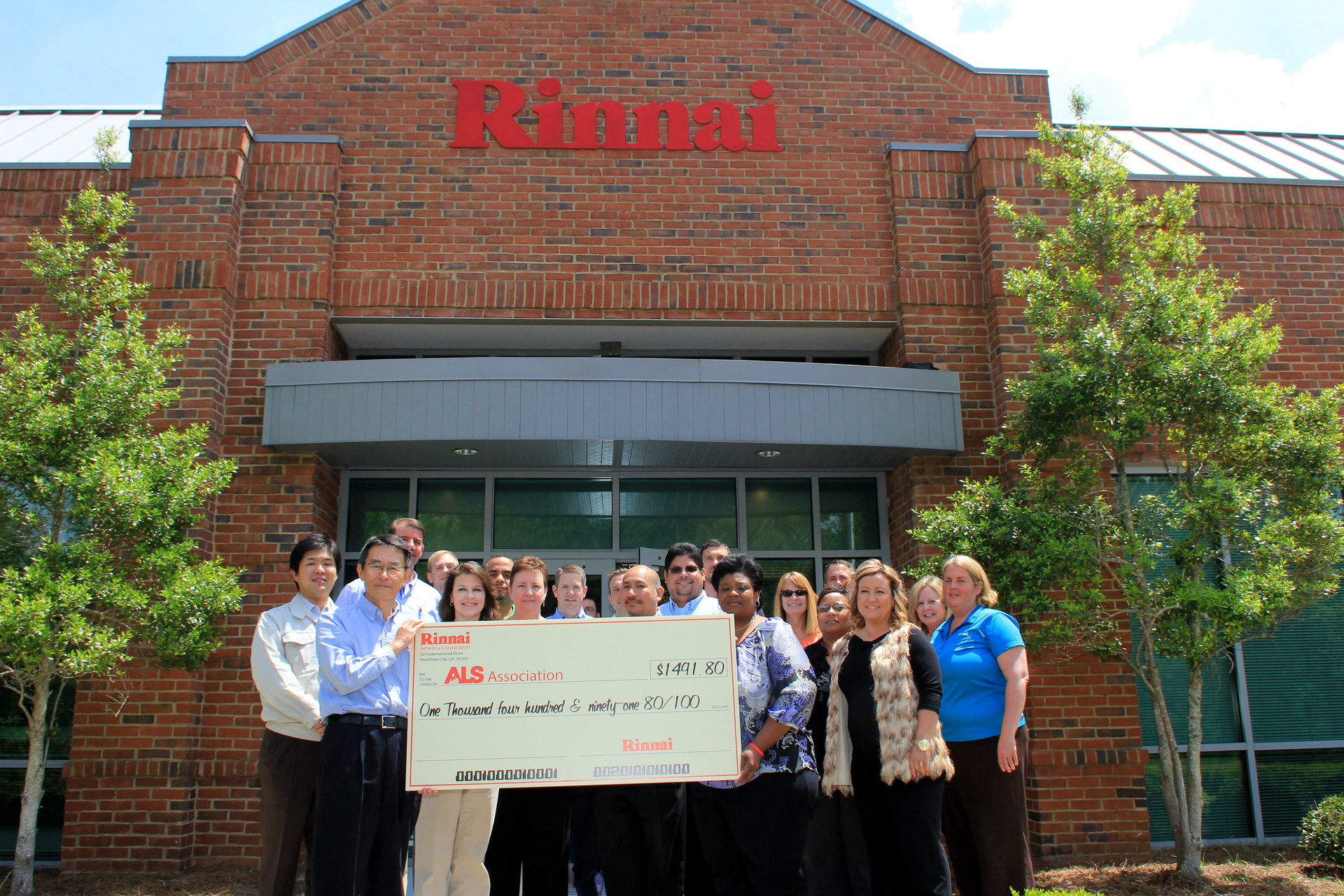 Rinnai America Corp employees with their donation check