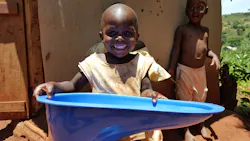 A young boy holds up one of the SaTo toilets A young boy holds up one of the SaTo toilets