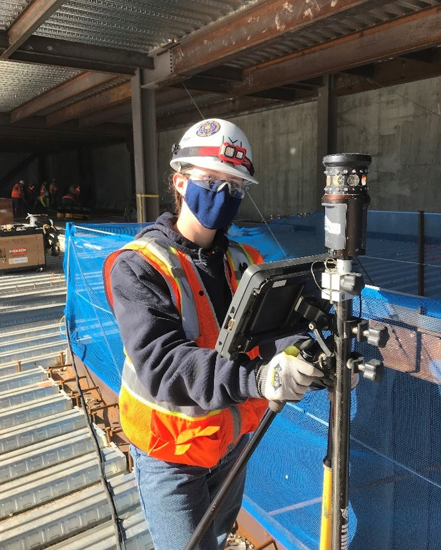 Megan Seabaugh (Pipefitter Apprentice), uses a laser scanner on the job site.