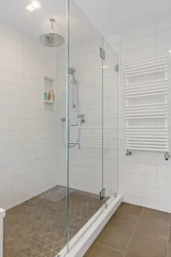 An Oventrop three-way mixing valve prevents higher temperature water meant for the heated towel bar from entering the radiant system. An Oventrop three-way mixing valve prevents higher temperature water meant for the heated towel bar from entering the radiant system.