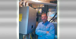 Noritz national account manager Gail Johnson inside his home’s mechanical room with the Noritz NRCB199-DV-NG Residential Condensing Gas Combination Boiler he installed for both space heating and domestic hot water. Noritz national account manager Gail Johnson inside his home’s mechanical room with the Noritz NRCB199-DV-NG Residential Condensing Gas Combination Boiler he installed for both space heating and domestic hot water.