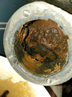 Photo #3 -- muck build-up inside the float chamber. Photo #3 -- muck build-up inside the float chamber.