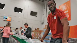 An SFA Saniflo volunteer helps pack meals for delivery. An SFA Saniflo volunteer helps pack meals for delivery.