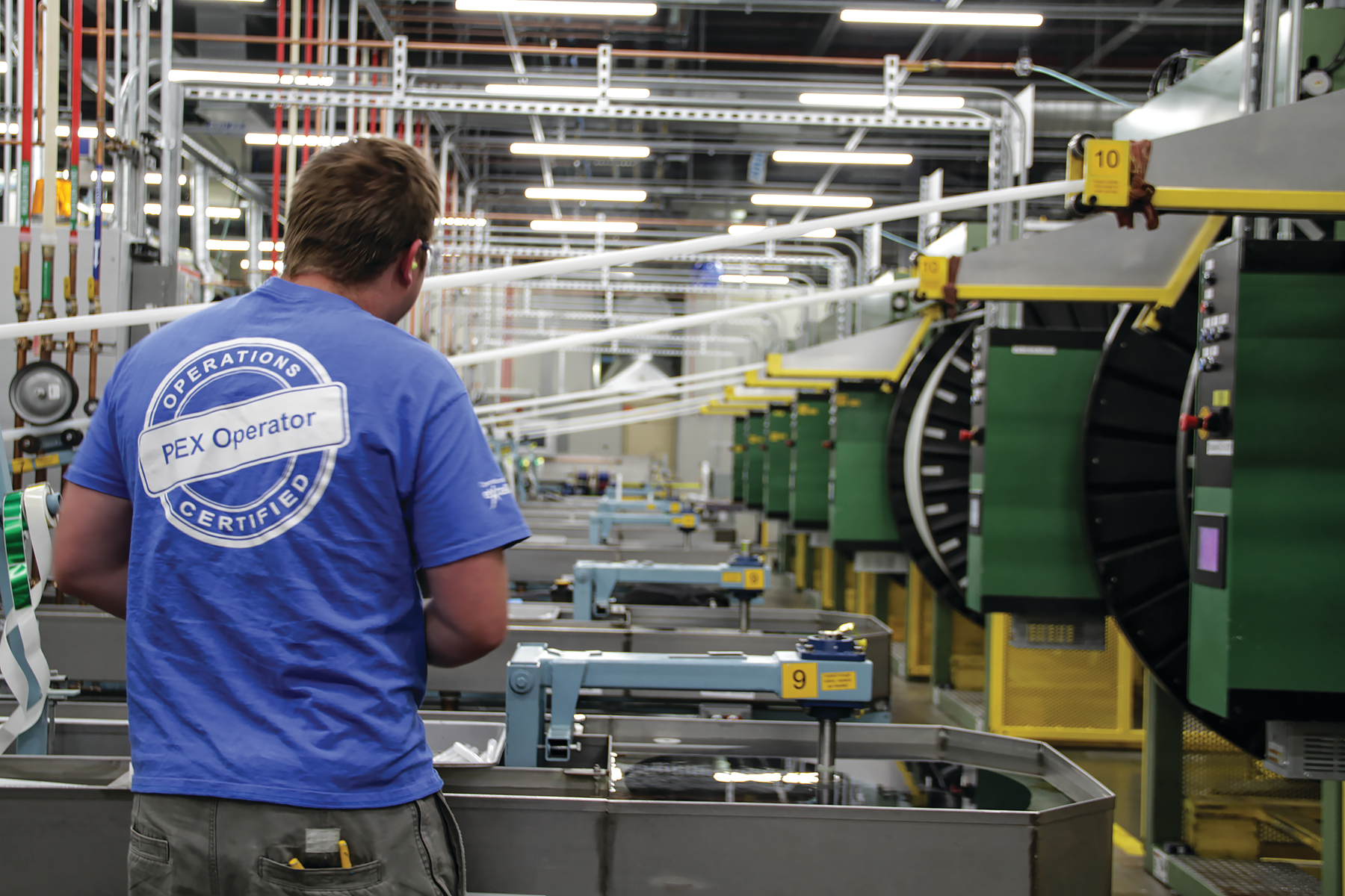 A worker on the factory floor at Uponor's PEX production facility.