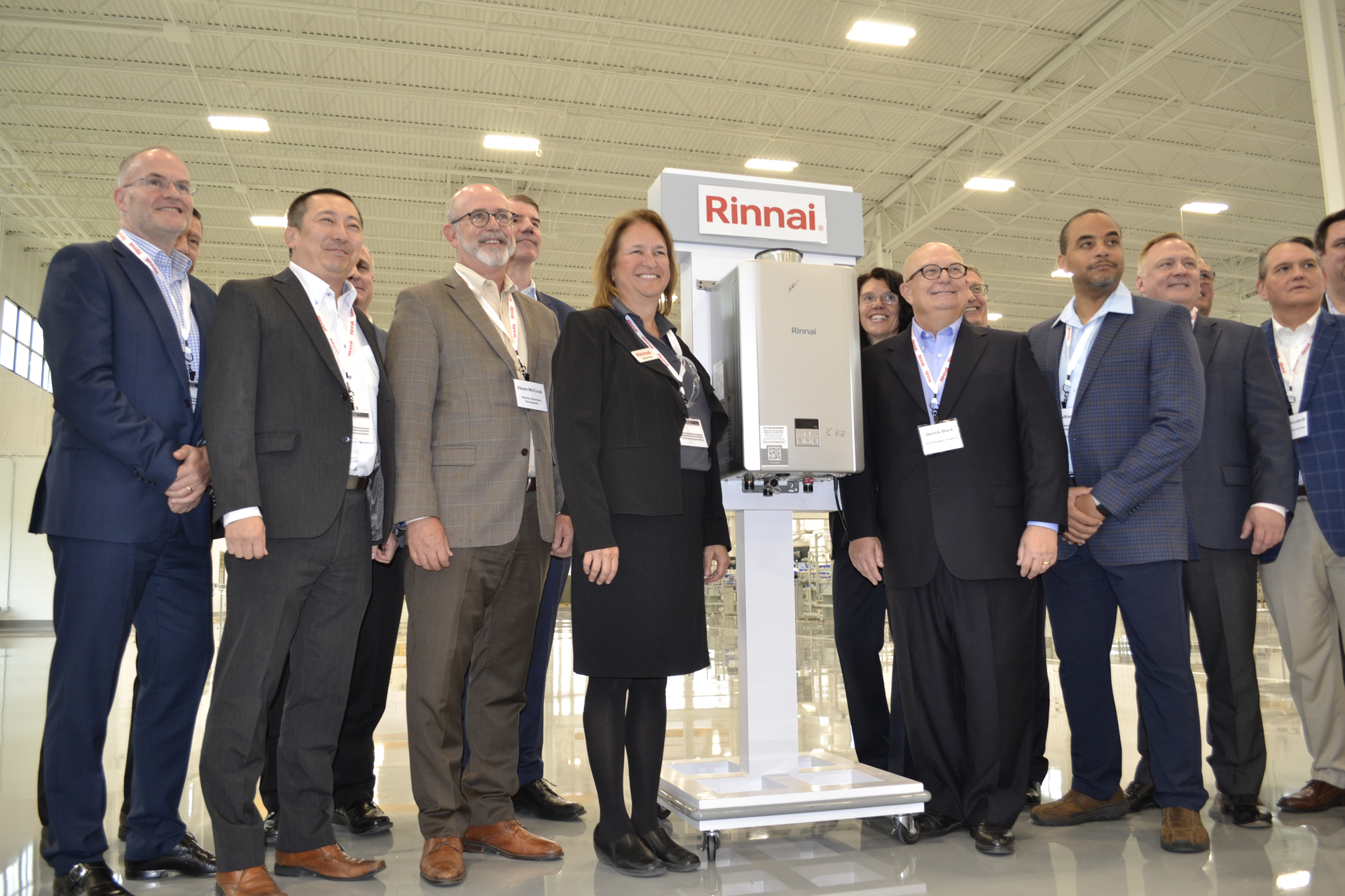 Rinnai executives gathered around the first tankless unit produced at the company's new Griffin, GA facility.