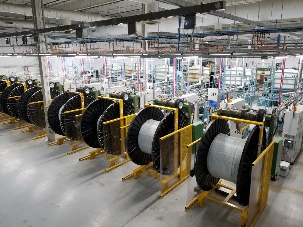 Spools of PEX tubing being wound on the Uponor factory floor.