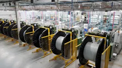 Spools of PEX tubing being wound on the Uponor factory floor. Spools of PEX tubing being wound on the Uponor factory floor.
