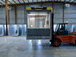A modular bathroom unit being transported from its assembly site to a shipping area. A modular bathroom unit being transported from its assembly site to a shipping area.