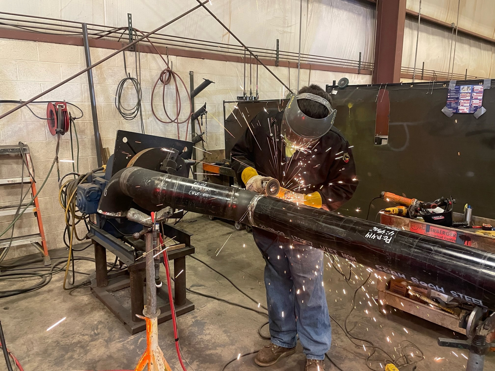 A Haberberger technician welds a section of cast iron pipe at the company's new piping facility.