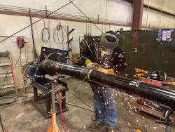 A Haberberger technician welds a section of cast iron pipe at the company's new piping facility. A Haberberger technician welds a section of cast iron pipe at the company's new piping facility.