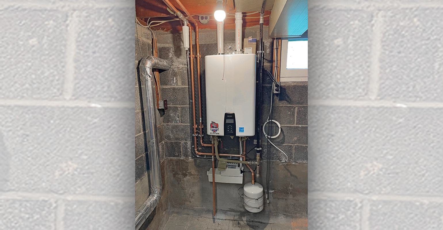 The finished tankless installation. The Sanicondens Best Flat unit can be seen underneath the Navien unit, just above the expansion tank.