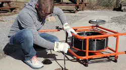A service technician cleans a drain. A service technician cleans a drain.