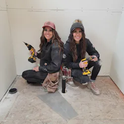 Two women drywallers who helped in the construction of the original House That She Built. Two women drywallers who helped in the construction of the original House That She Built.