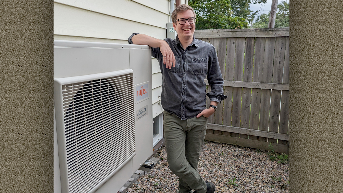Homeowner Ryan Kelly with his new heat pump.