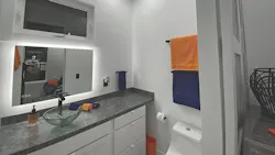 The bathroom includes a full-size shower, a sink and the Saniflo Rear Discharge Toilet. The bathroom includes a full-size shower, a sink and the Saniflo Rear Discharge Toilet.