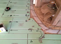 Pex tubing routed across the main level to an access hole for the basement level. Pex tubing routed across the main level to an access hole for the basement level.