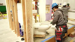 An in-wall carrier system being installed. An in-wall carrier system being installed.