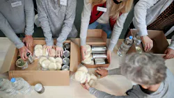 Volunteers working at a community food bank. Volunteers working at a community food bank.