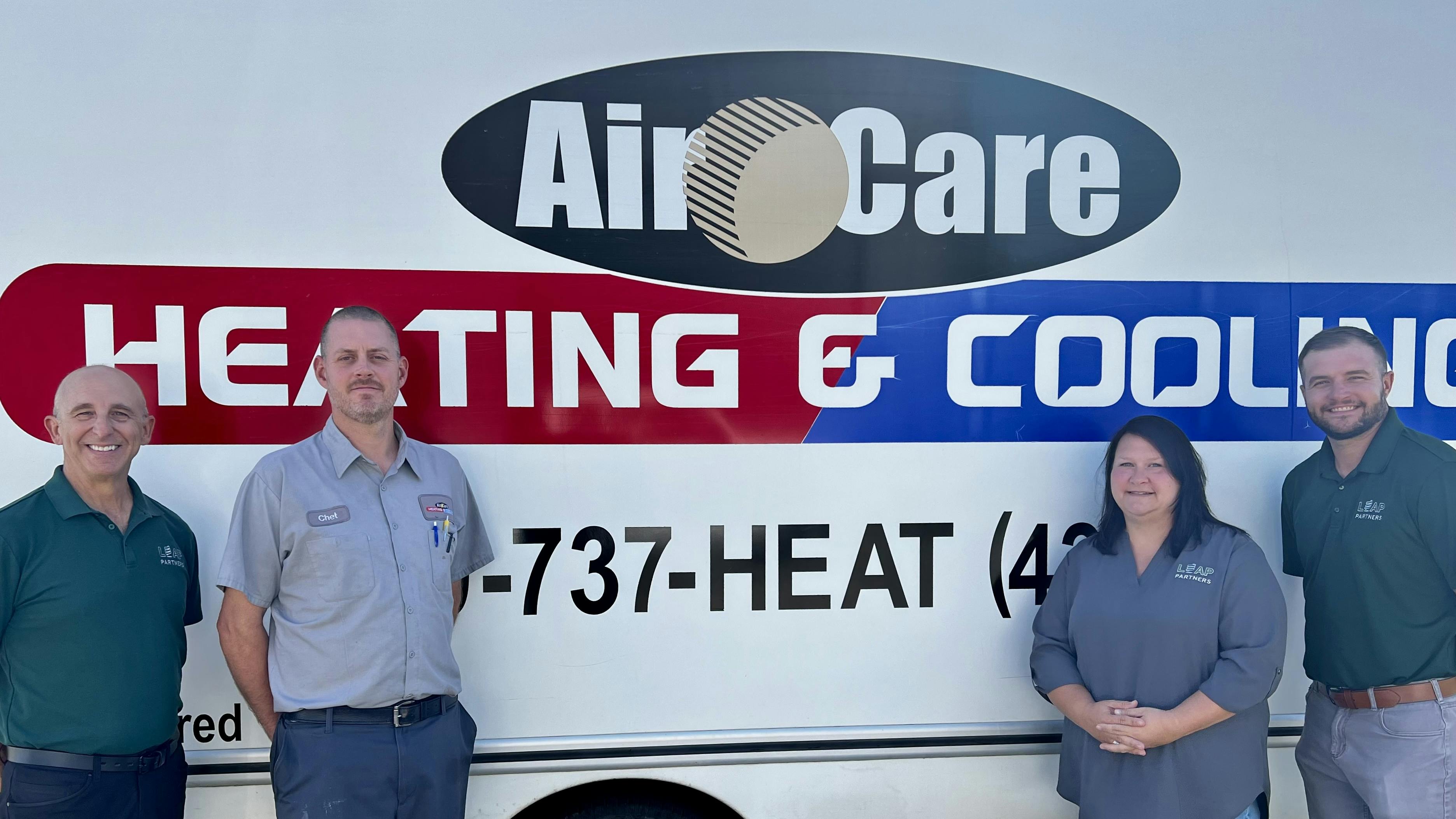 Leap Partners CEO John Cerasuolo; Air Care owner Chet Lovall; Kristi Toth, VP of HR, Safety and Risk; and Mitch Mobley, regional VP of Operations, smile together for a photo during the acquisition of Air Care.