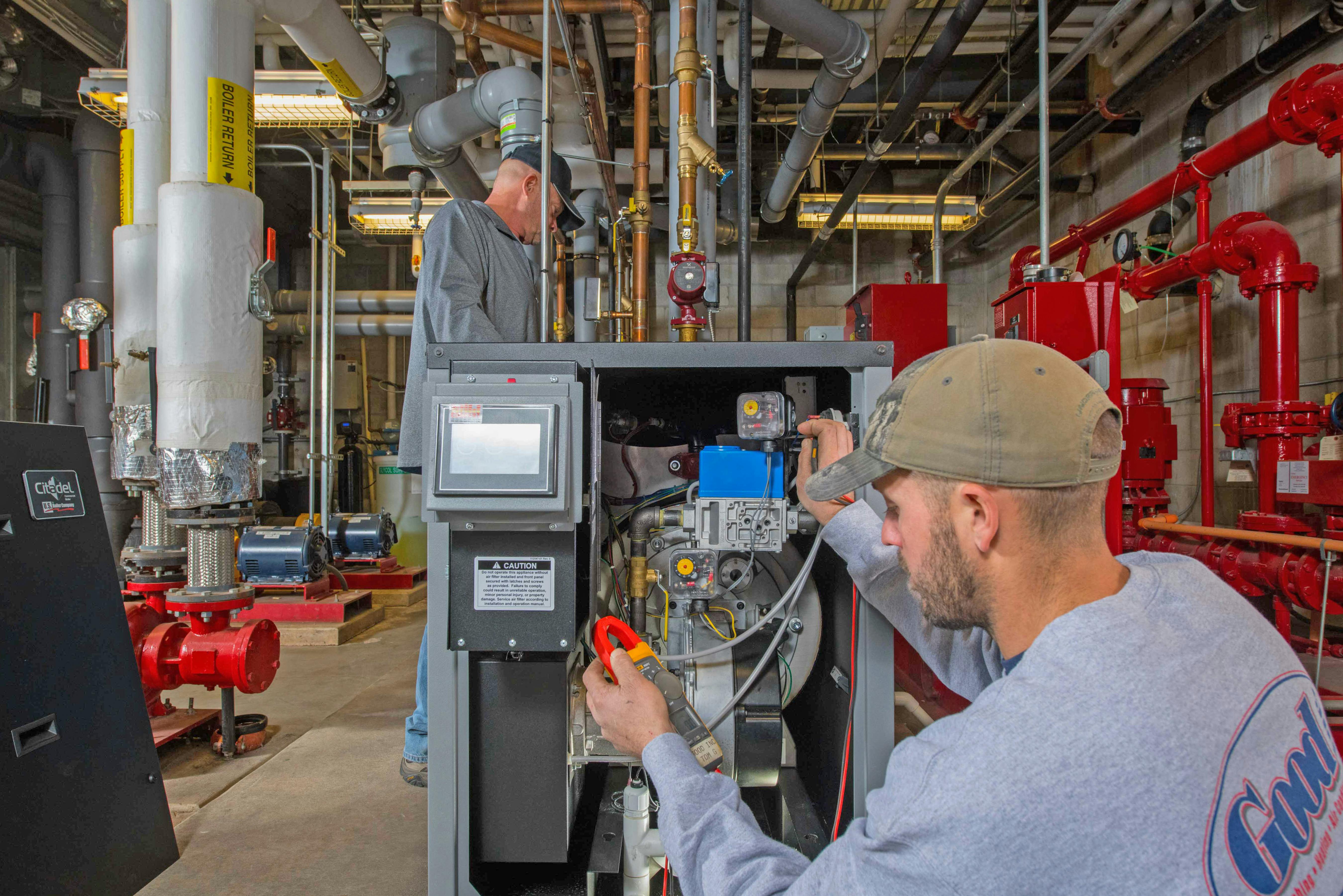 Good&rsquo;s Project Manager, Don Landis (L), and Lead Mechanic, Tom Grasse in the boiler room at Our Lady of Guadalupe.