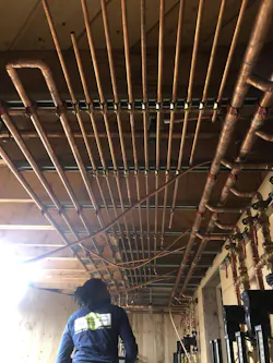 Connecting copper radiant loops to the manifold. Connecting copper radiant loops to the manifold.