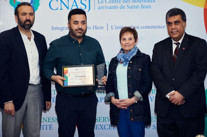 Fahad Khan, second from right, Plant Director of NTI Boilers, accepts the Outstanding Business Partnership Award from the Saint John Newcomer Centre. Presenting the award are Emin Civi, Chairperson of the Board at Saint John Newcomers Centre, left; Nancy Grant, Mayor of Rothesay, second from right; and Mohamed Bagha, Managing Director at Saint John Newcomers Centre.