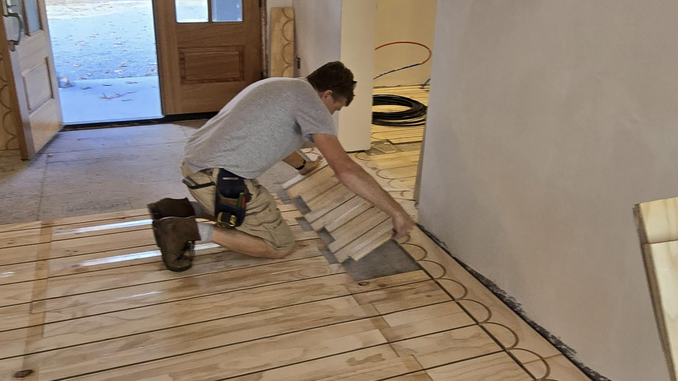Installing a section of the radiant floor.