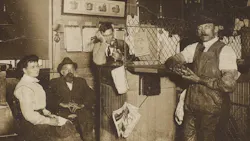 John Bouchard (seated) with employees. John Bouchard (seated) with employees.
